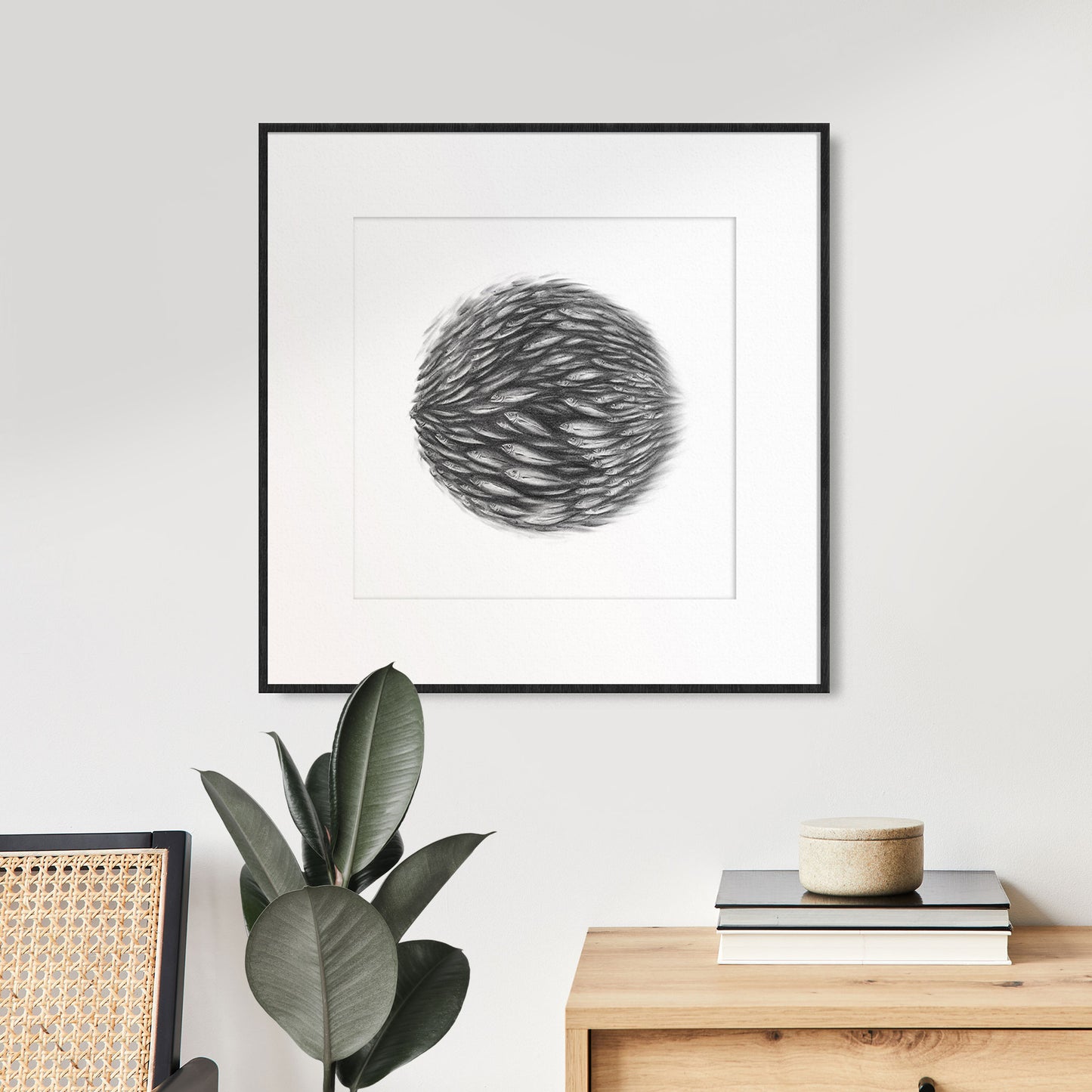 A black and white charcoal drawing of a bait ball school of fish in a sphere shape